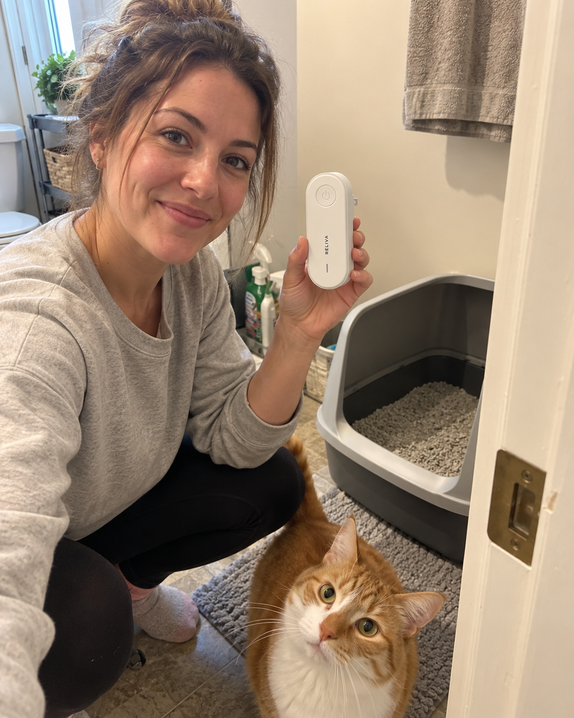 Cat owner holding PurrAir in a real home